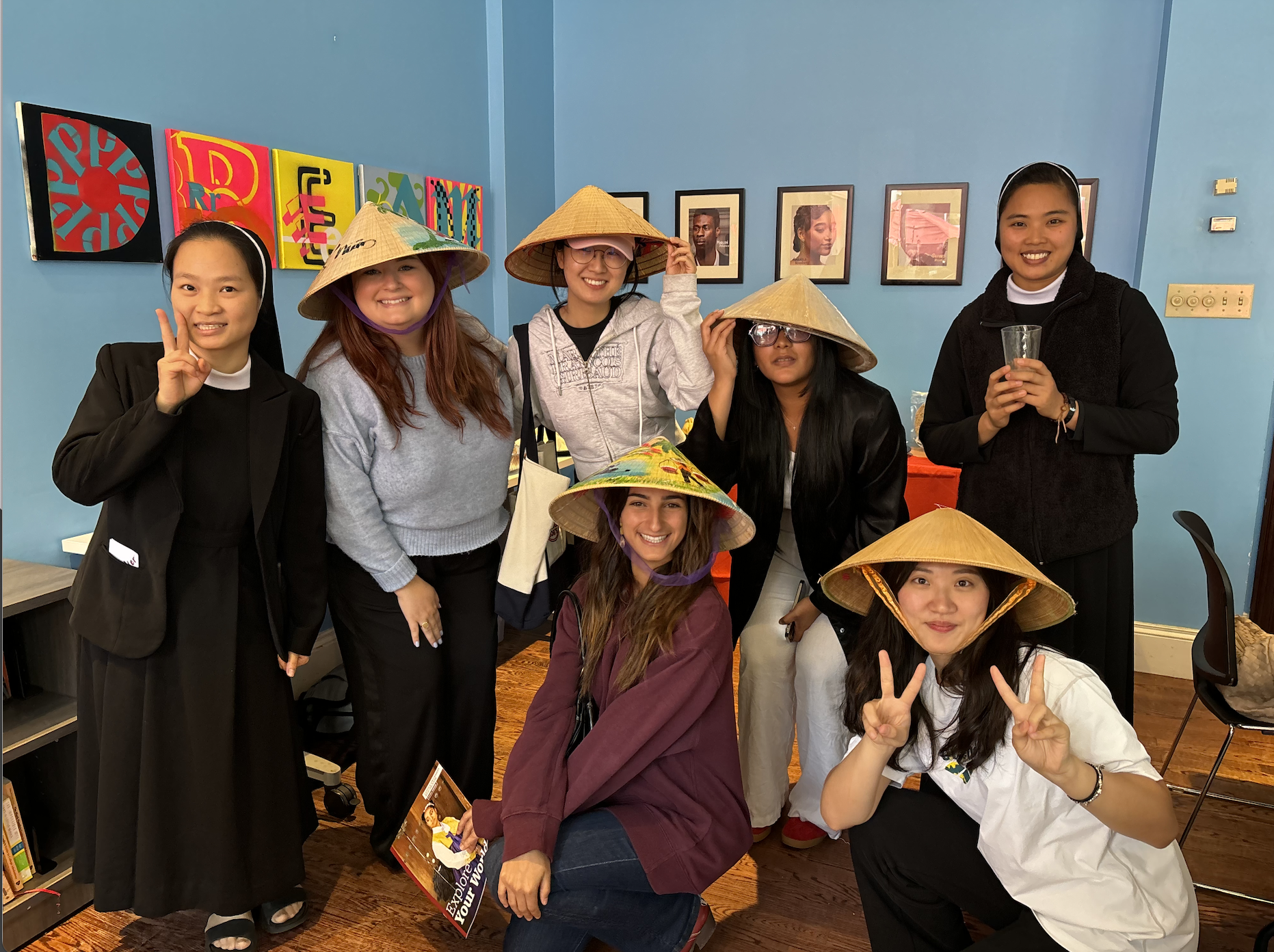 Picture of students and CIE staff at April 2025 Culture Cup wearing traditional Vietnamese straw hats.